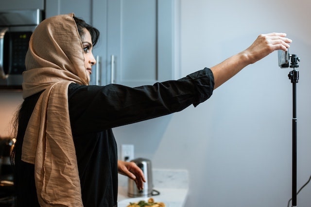 Woman setting up a mobile phone for filming