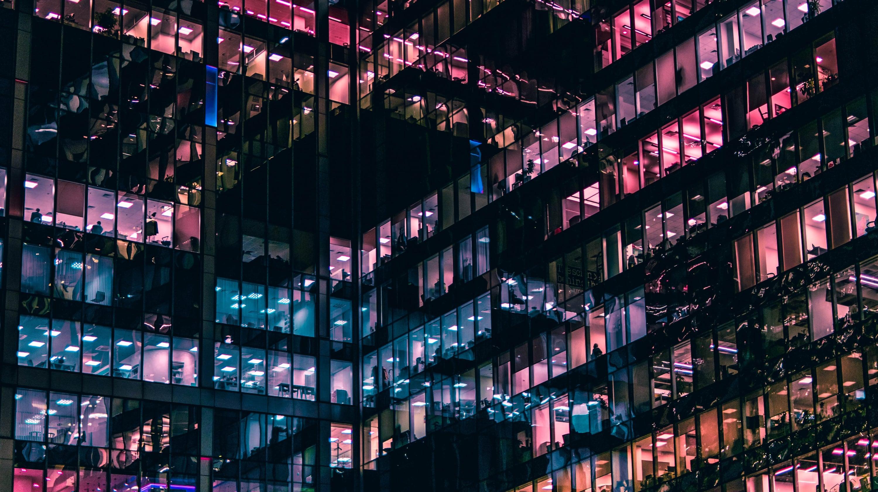 Multi-coloured windonw on a large business building at night