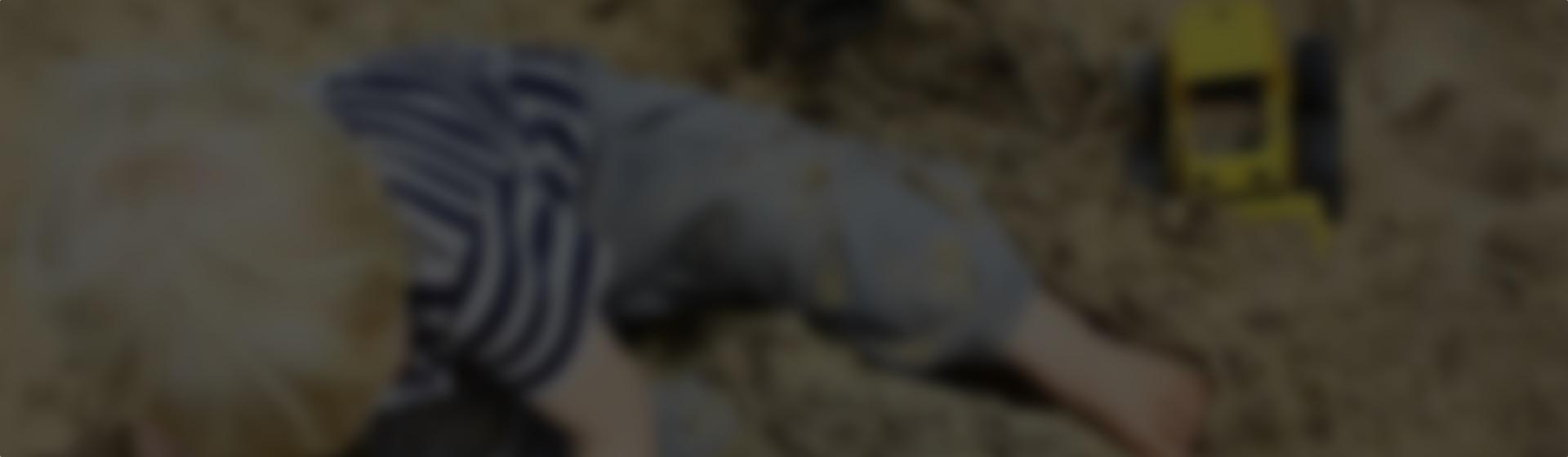 boy playing in a sandbox