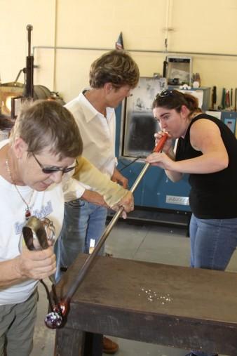 Blogger Ashley Grant blowing glass