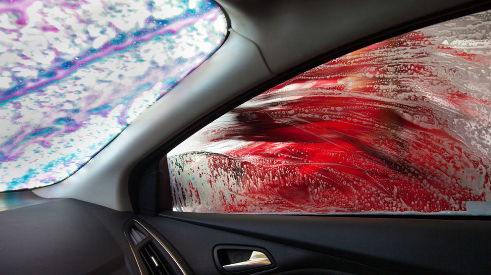 Interior of car looking through windows at carwash