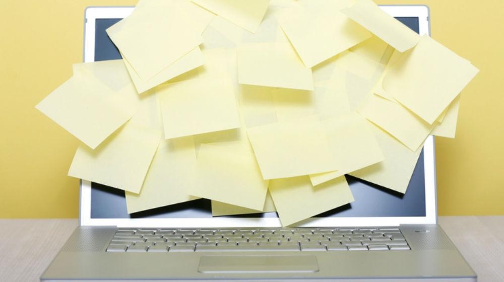 laptop covered in post-it notes