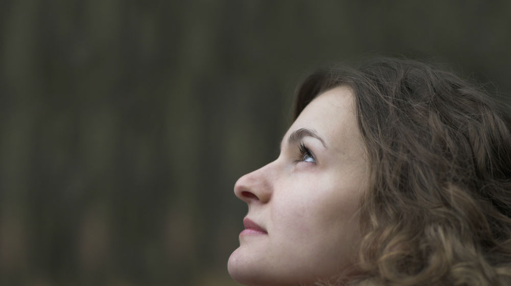 woman looking up in thoughtful contemplation