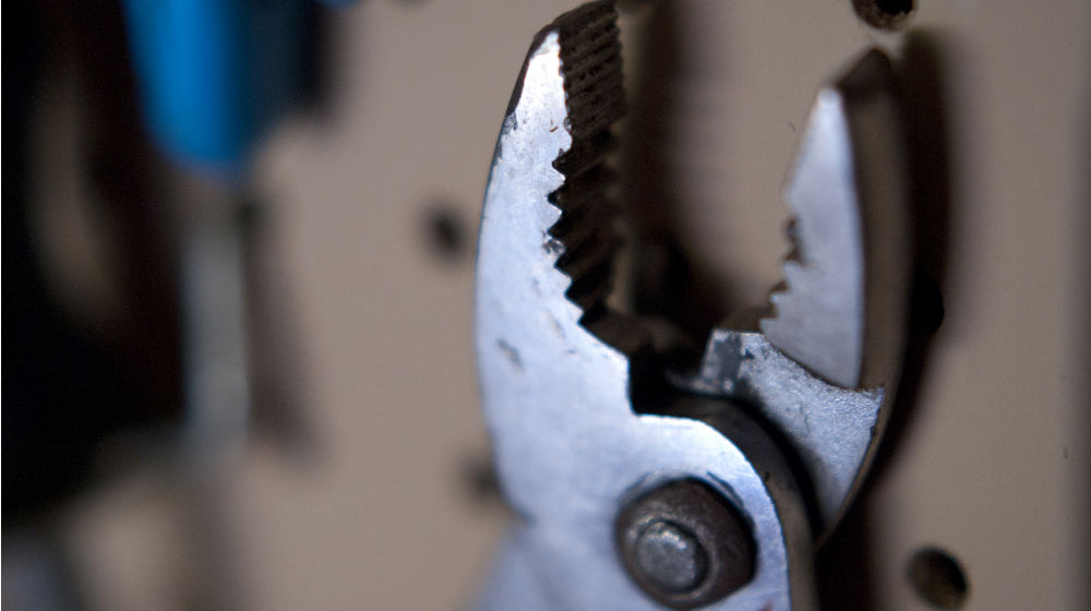 wrench to illustrate need to tighten security for website by patching magento and updating wordpress plugins