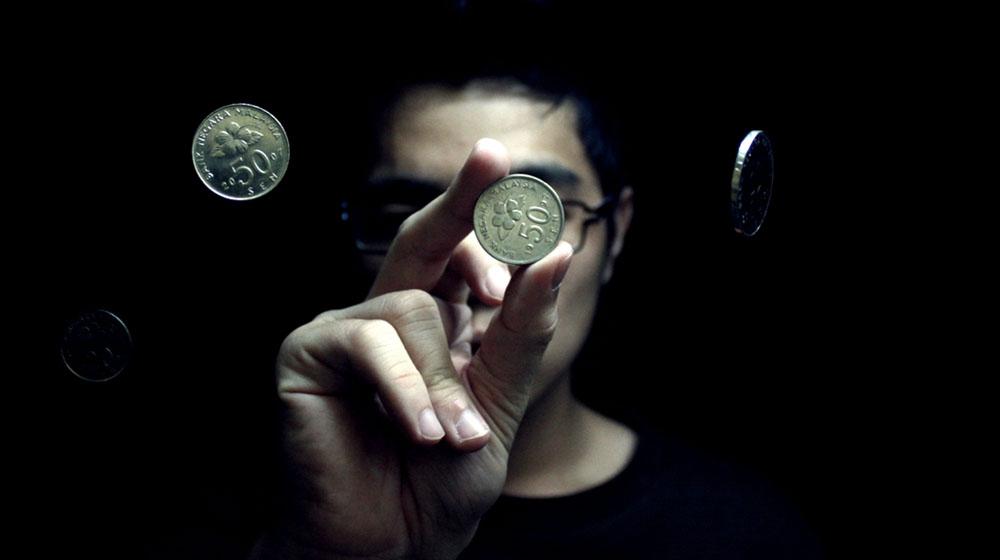 guy doing a magic trick with coins to represent css tricks with images