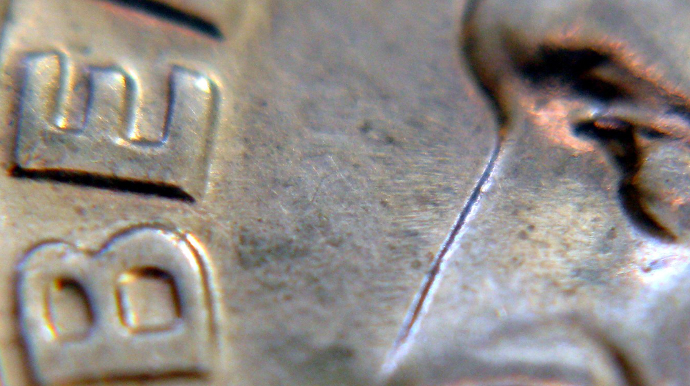 Closeup of quarter to represent fact that making money for art doesn't equate to selling out
