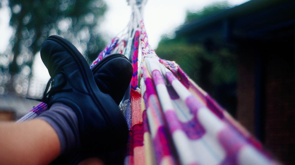 Feet Sitting on Colorful Hammock