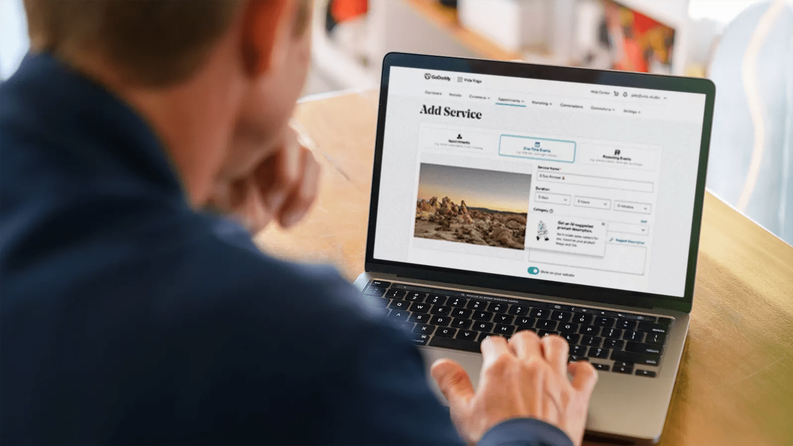 A Man Works on a Laptop Registering a Domain Name