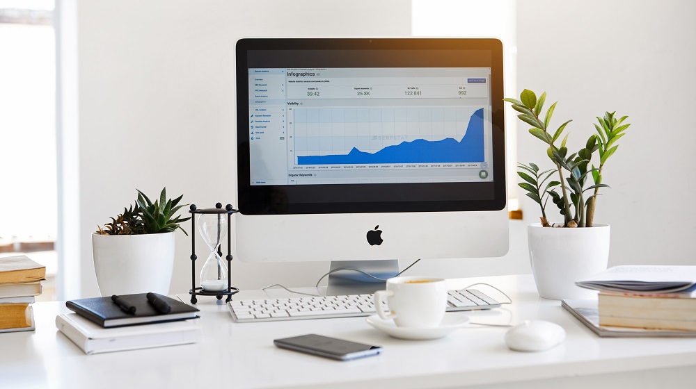 Desktop Computer With Chart Illustrating Business Plan Financial Projections
