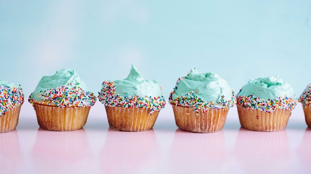 Cupcakes with Sprinkles on Blue and Pink Background