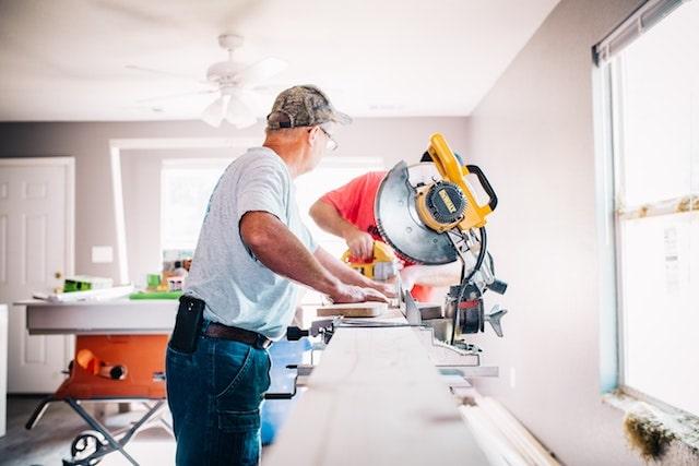 Contractors Working in Home with Saw