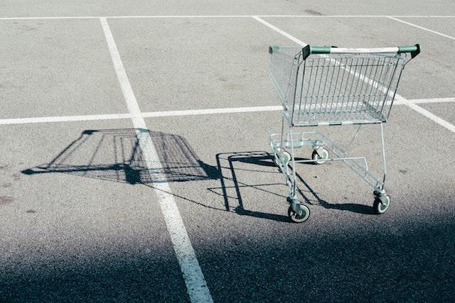 Shopping cart alone in a parking lot