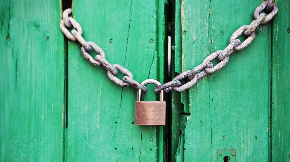 Lock on Chain Against Green Door