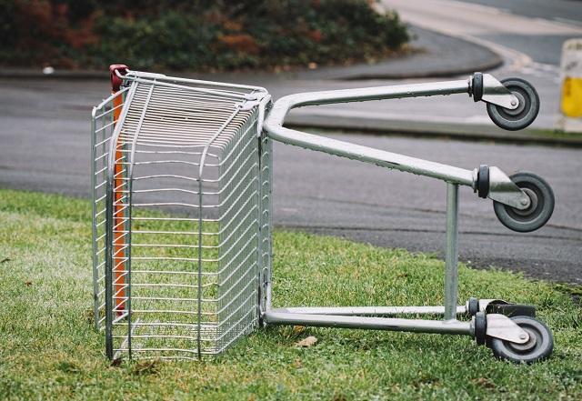A Wire Shopping Cart Lays on Its Side