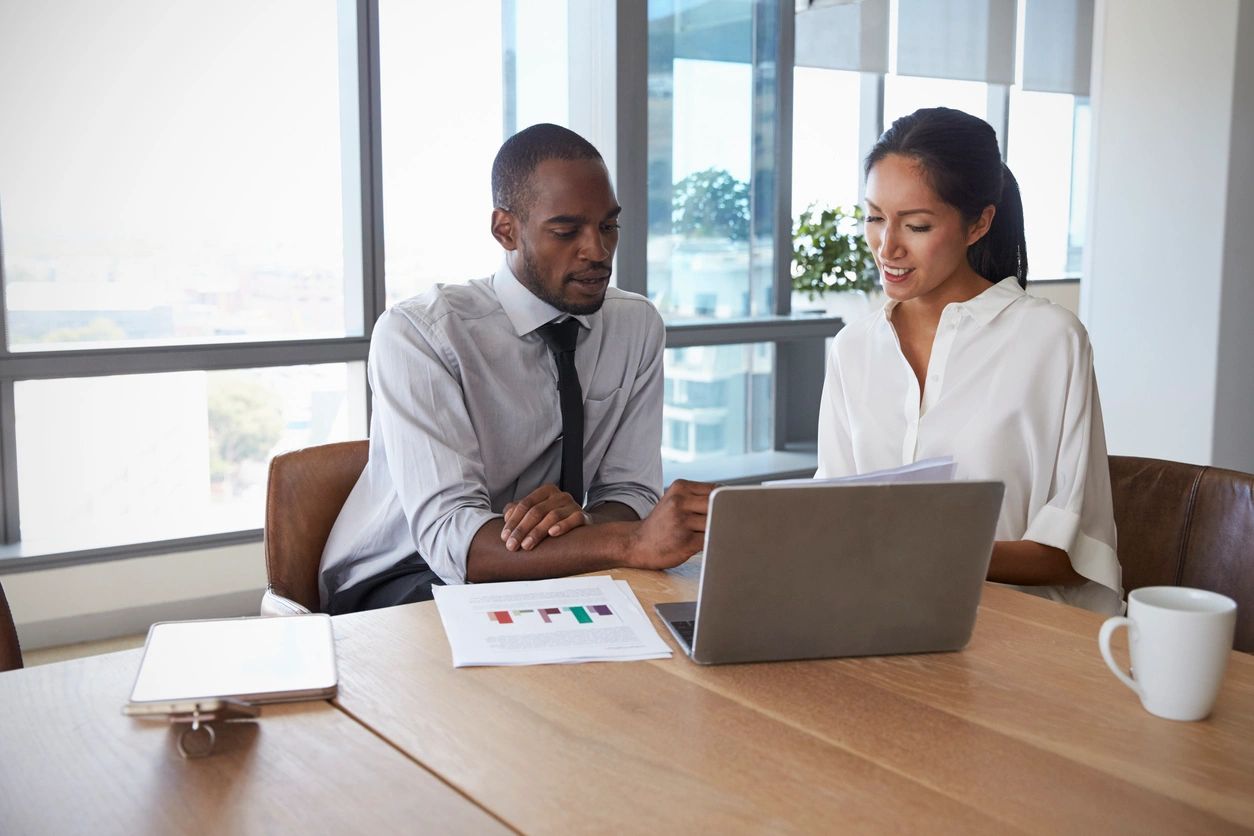 Two people taking about a website project