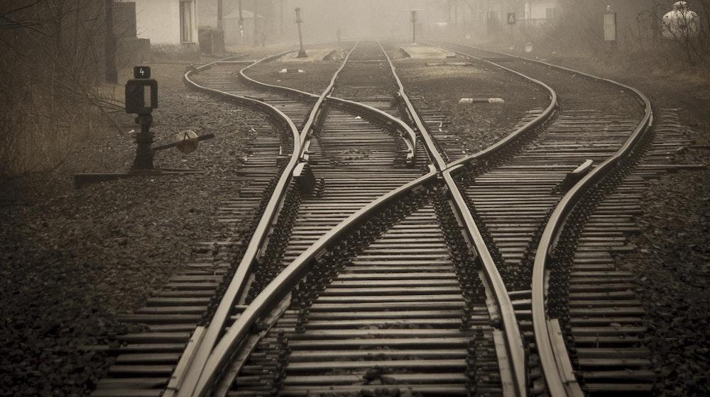 black and white image of train tracks