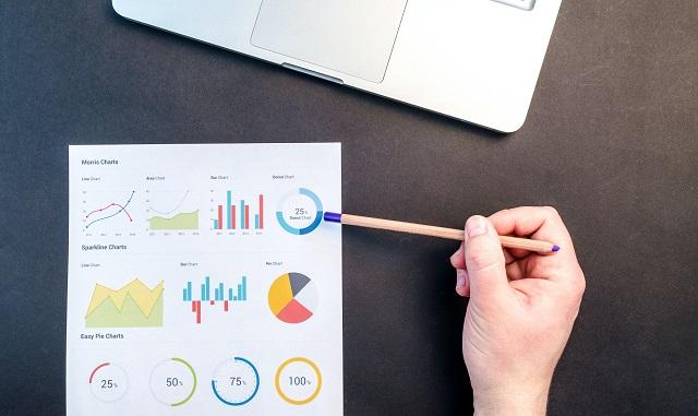 Data chart on a desk with a laptop