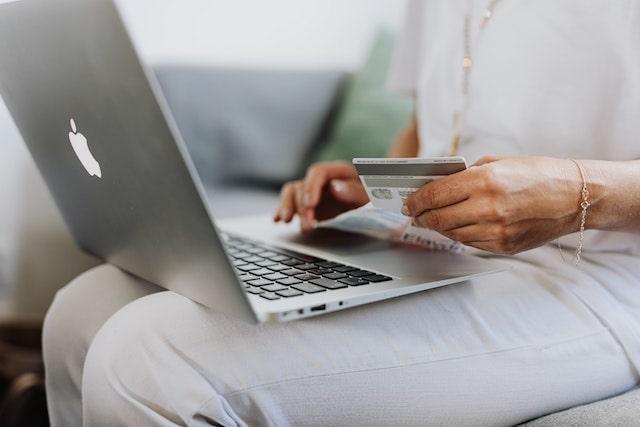 Woman shopping online with credit card