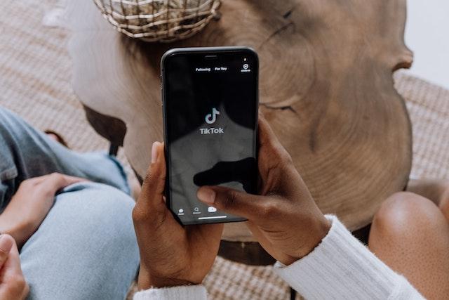 Person opening TikTok on smartphone