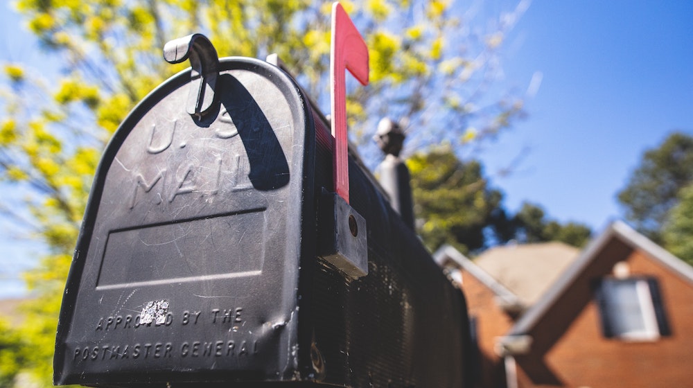 Black mailbox in front of house
