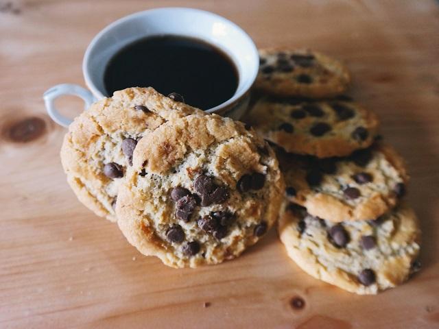 Pile of cookies resting near coffee cup