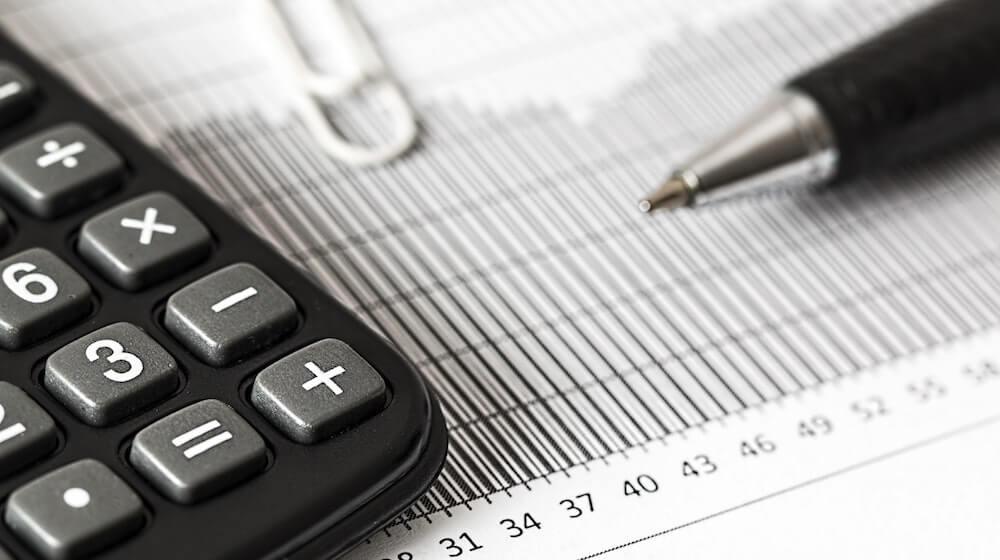 Calculator and pen on paperwork