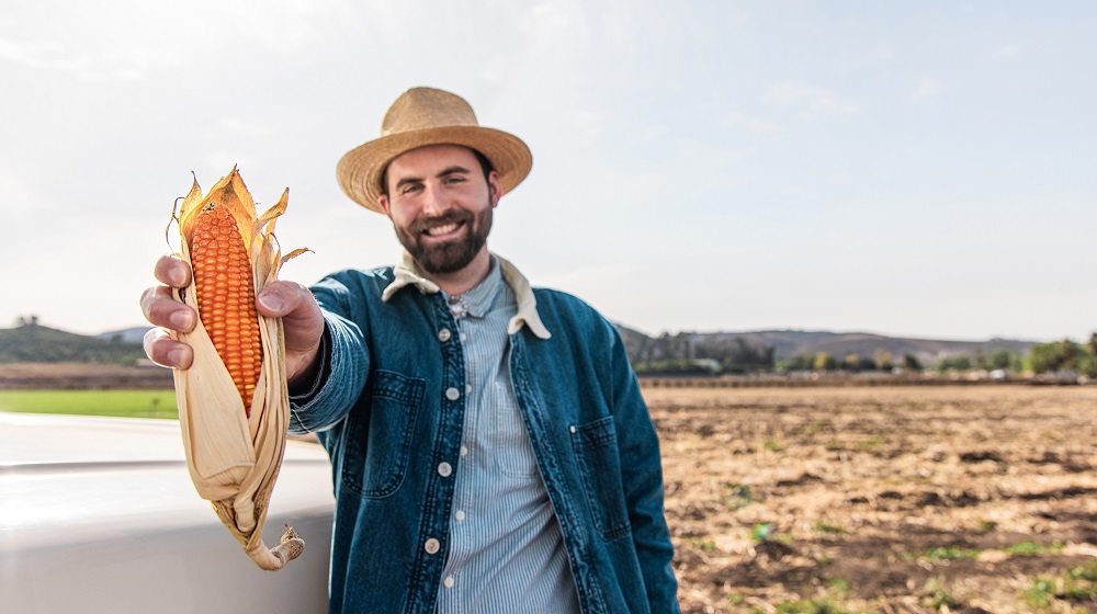 NutraMaize™ CEO Evan Rocheford Holding Orange Corn