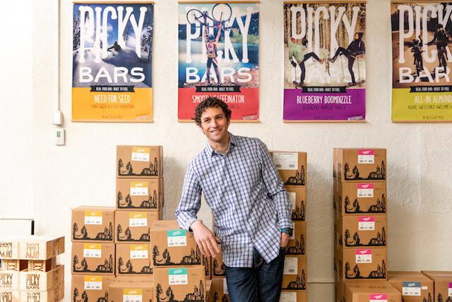 Jesse Thomas with boxes of PIcky Bars