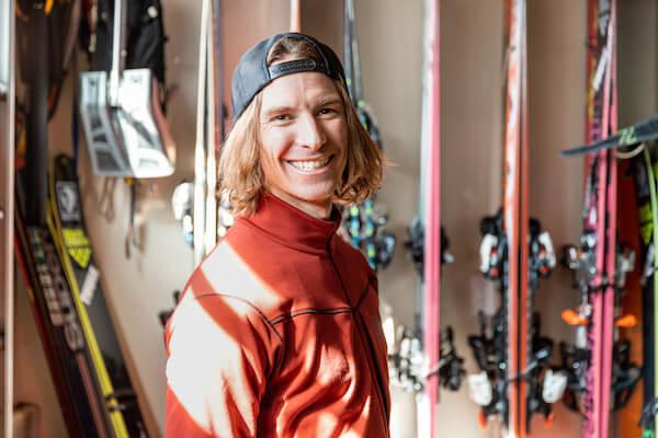 Mattias Giraud smiling in front of skis