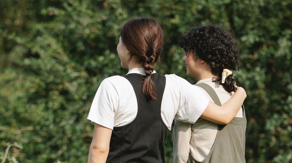 Two women outside standing next to each other