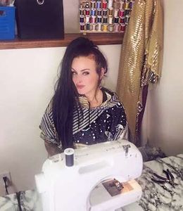 Kelly sitting at sewing machine