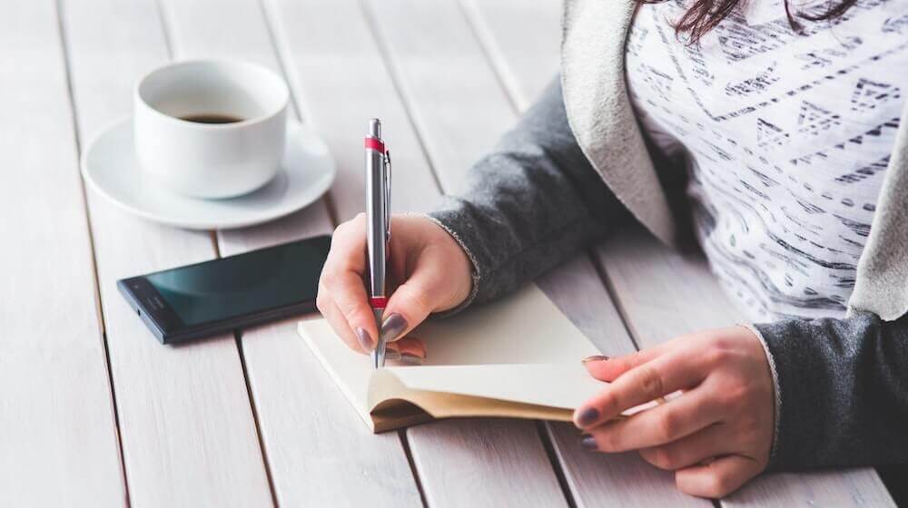 woman writing in notebook