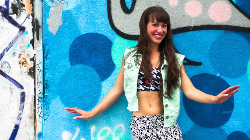 Natasha Williams posing in front of painted wall