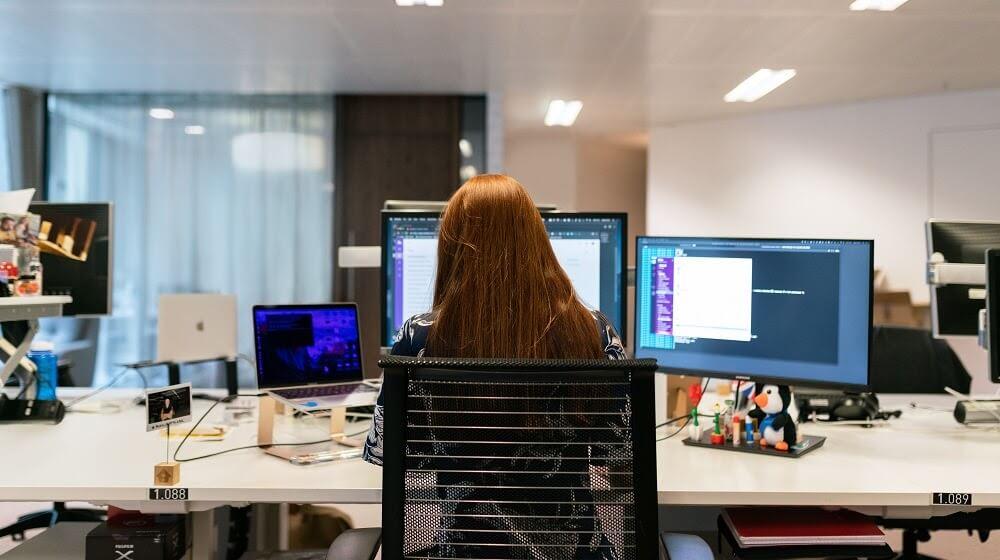 Engineer reviewing code at workspace