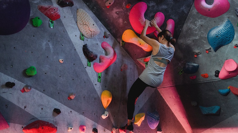 Rock climber assessing their next move upward