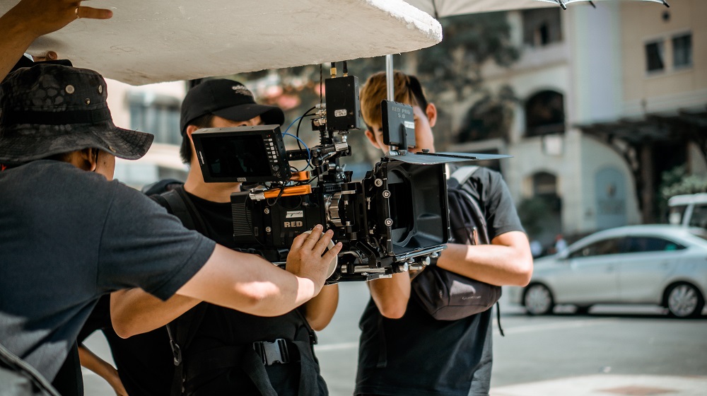 Three men working on a movie set