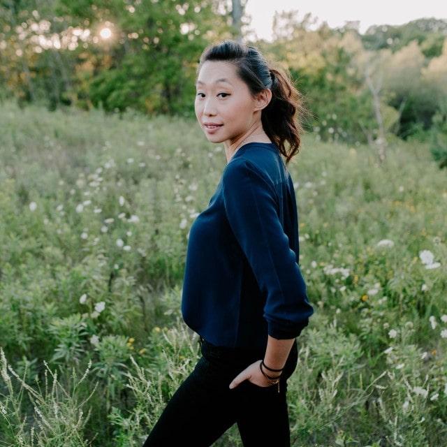 Annie Tang standing in a grassy field
