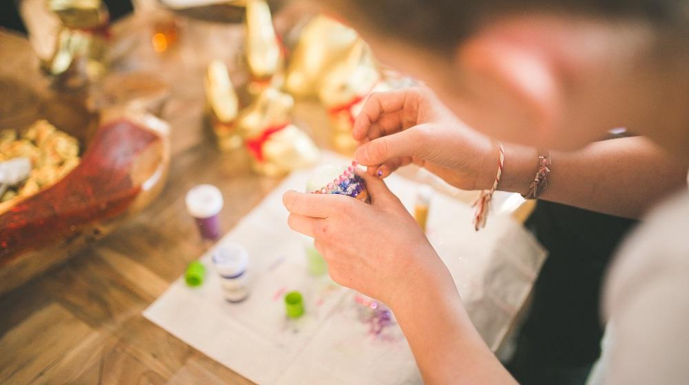 Woman concentrating on creating gemmed artwork
