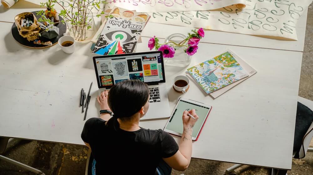 Person designing on iPad at desk