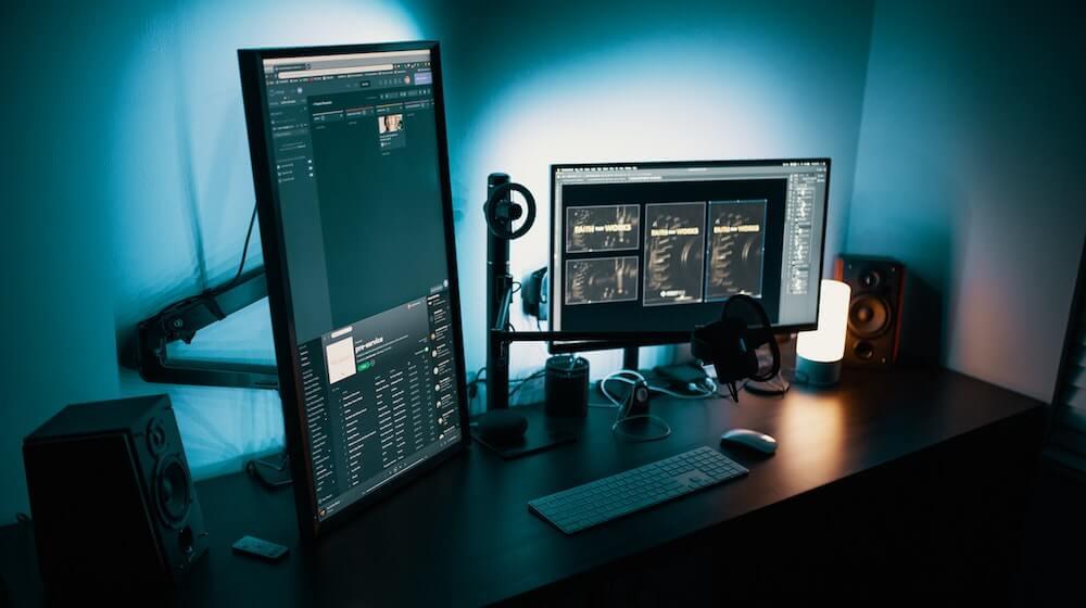 multiple computer monitors on desk
