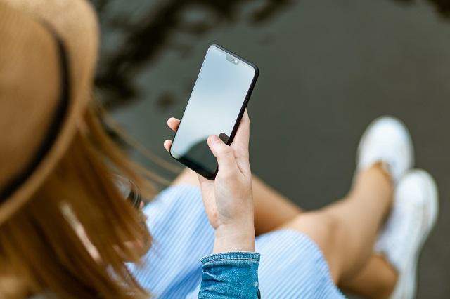 Person using their smartphone on the beach