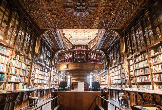 Large ornate library with shelves stretching out of frame