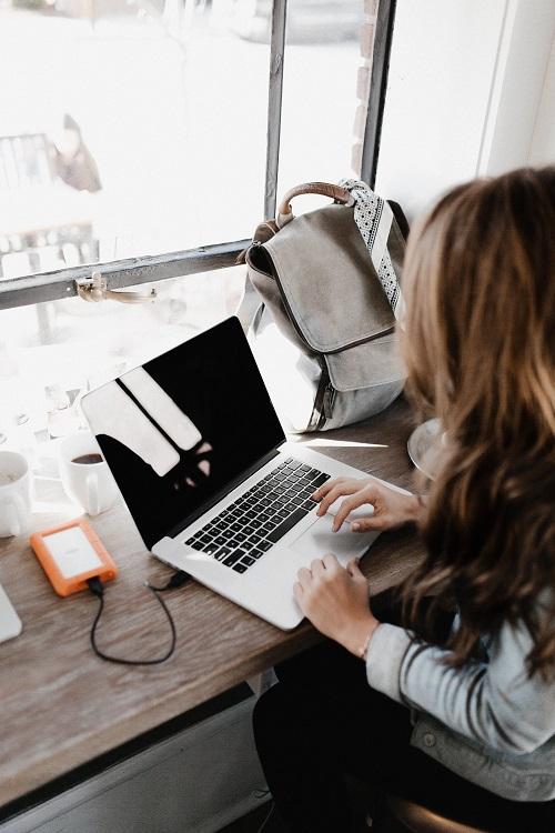Woman working on laptop in a sunny room