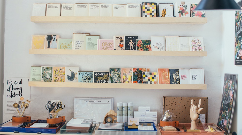 Stationery store display with cards on shelves