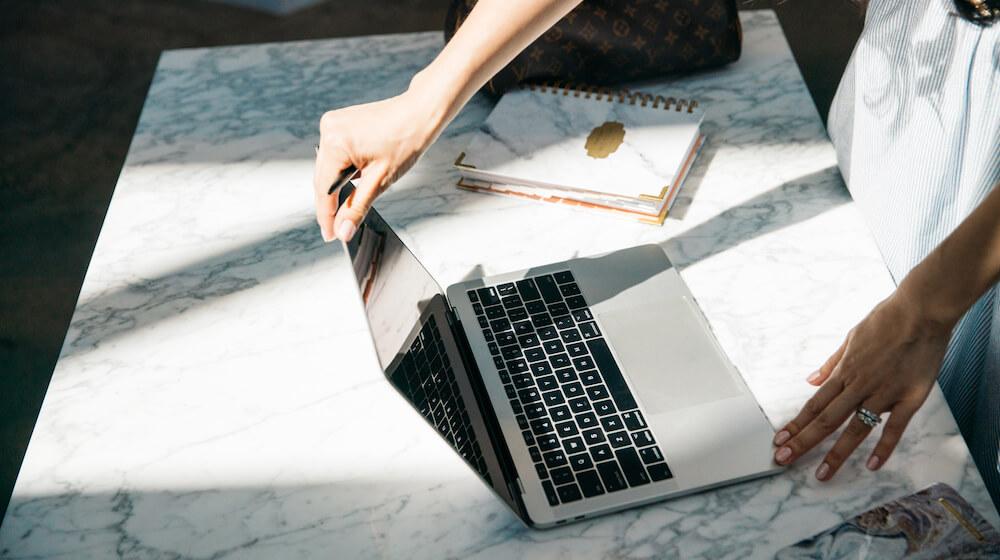 Woman opening laptop