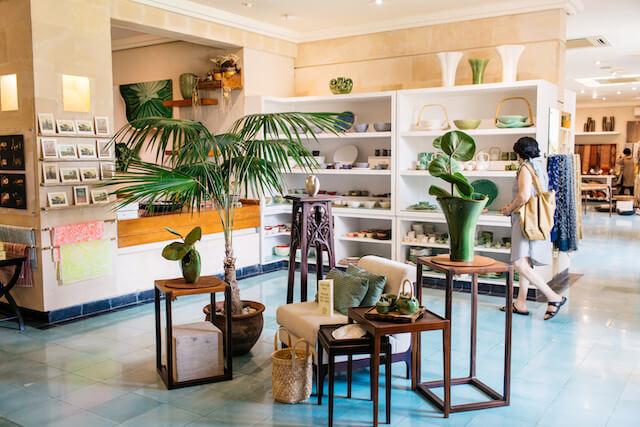 Inside view of a retail store with woman shopping in the background