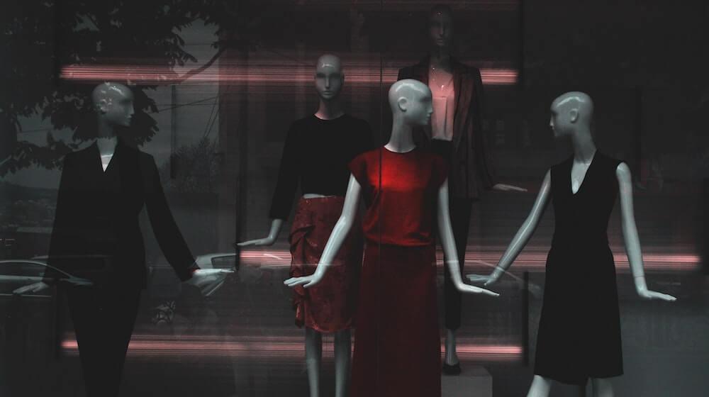 Red dress on display around black dresses