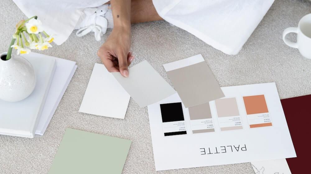 woman sitting on floor looking at color swatches