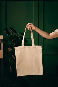 Person holding canvas tote bag