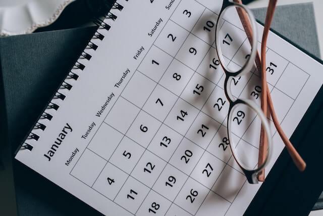 January calendar with glasses resting on it